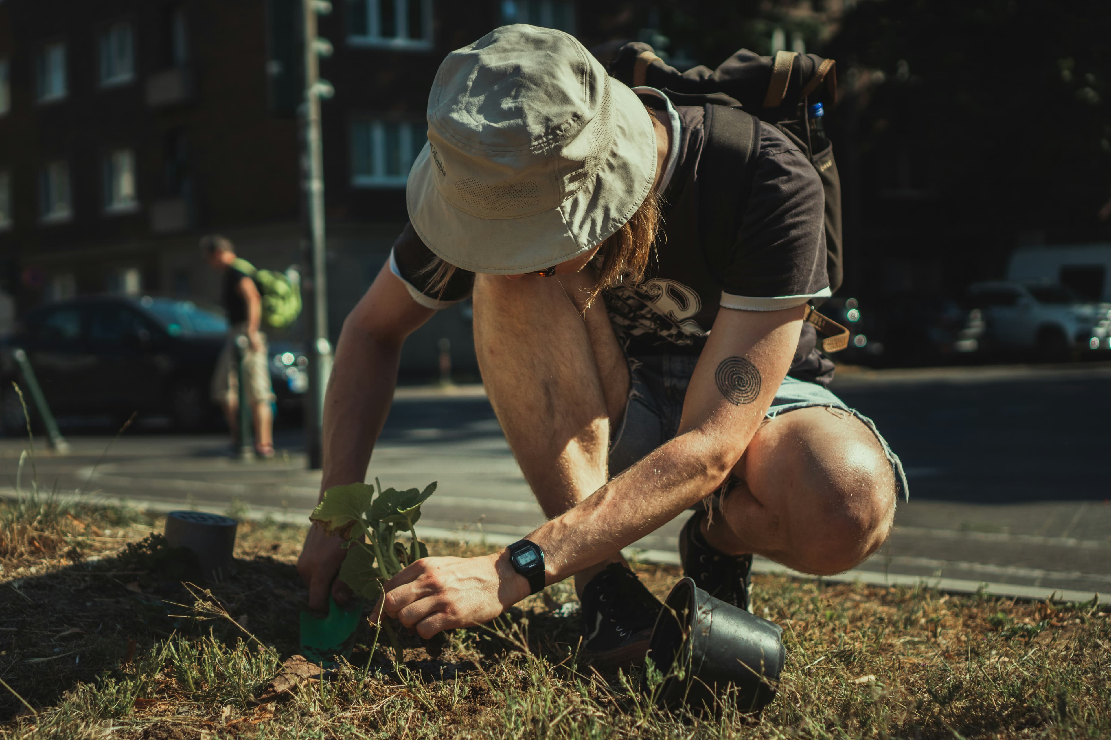 Picture of a man gardening in an urban setting